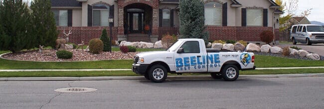 A Beeline's truck is parked in front of a home
